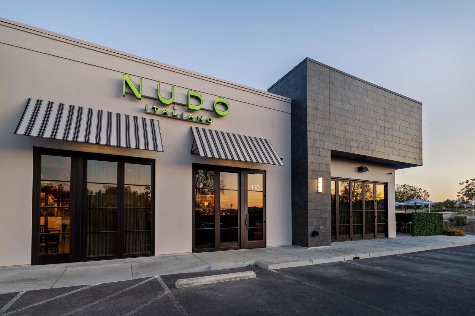 The Nudo Italiano entrance on W Cactus Ave, with striped awnings and the green wordmark