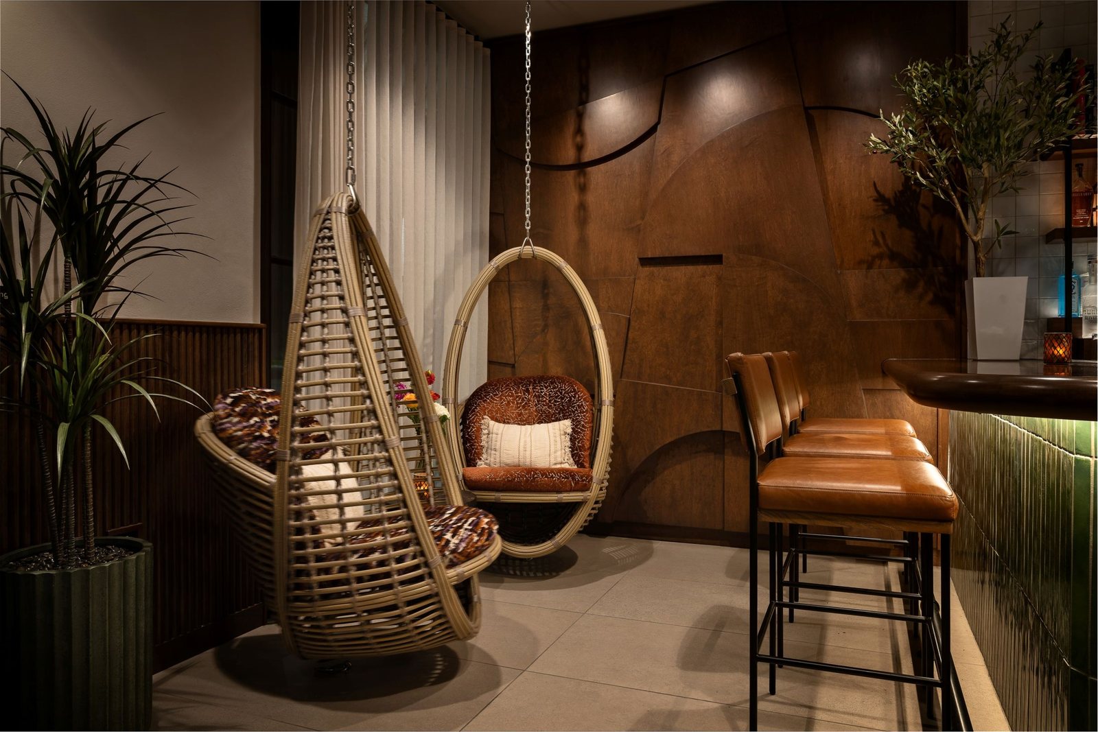 Woven swinging chairs beside the Nudo bar and lounge