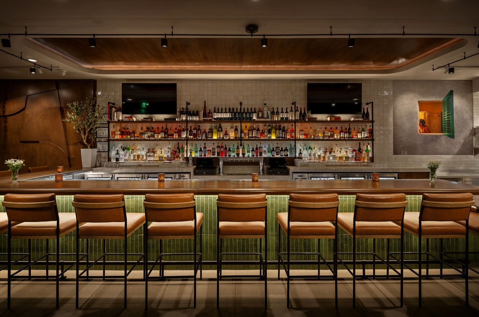 Leather bar stools along the tiled bar at Nudo Italiano