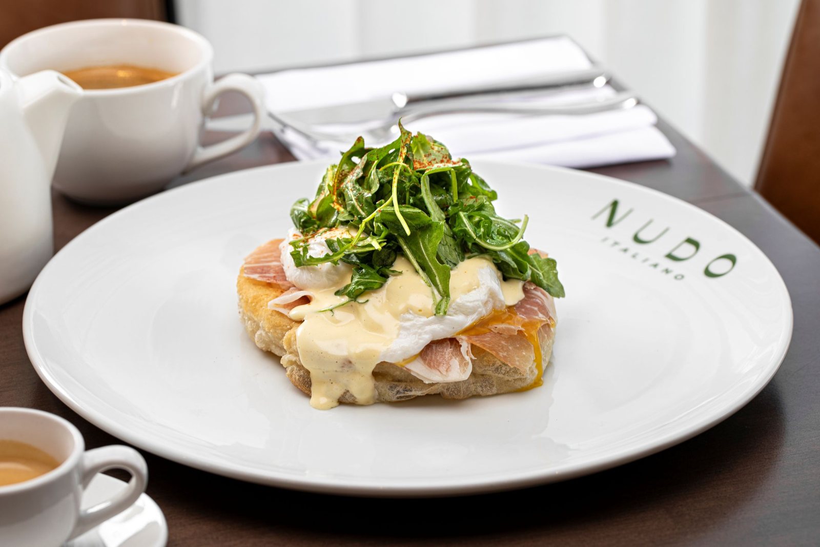 Prosciutto Benedict with poached eggs and greens